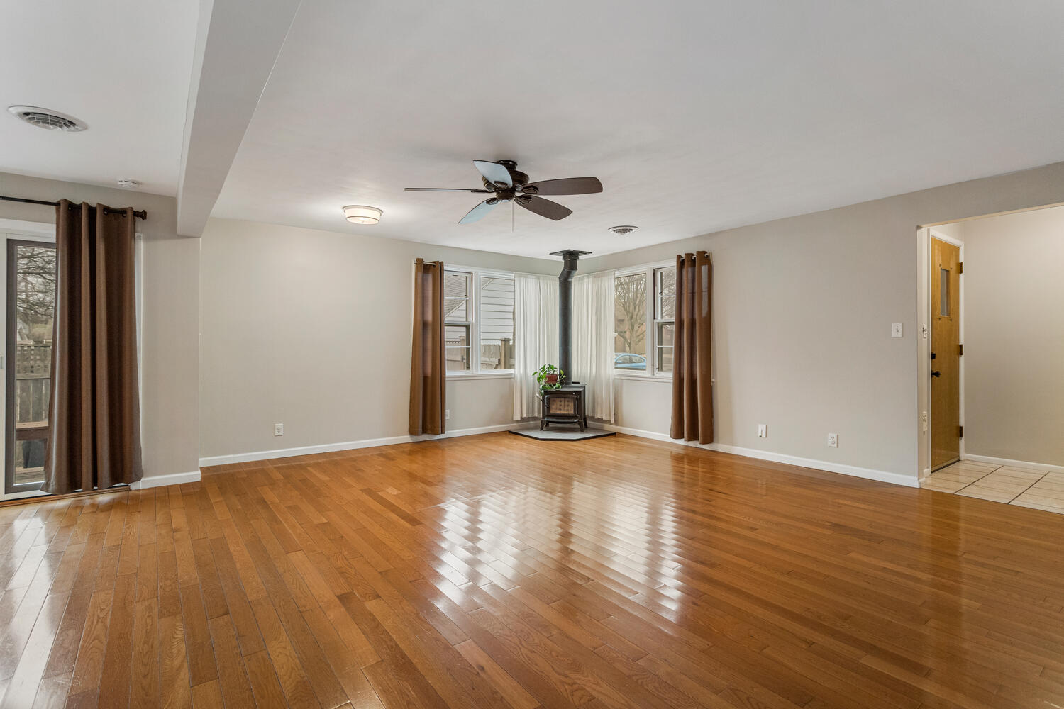 1111 West John Street Champaign, IL 61821 - Photo 7 of 39 a view of an empty room with window and wooden floor