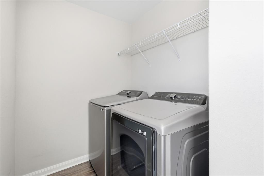 227 Curt Street Anna, TX 75409 - Photo 31 of 40 Laundry room featuring washer and dryer and wood finished floors