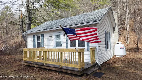 a view of a house with a yard and deck
