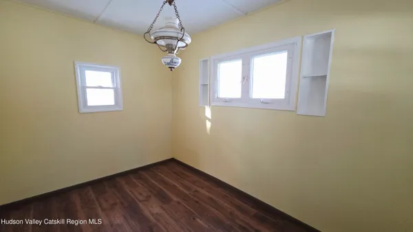 a view of a livingroom with wooden floor and stairs