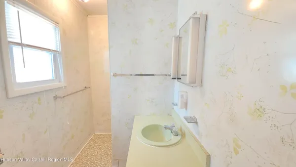 a view of a room with wooden floor and windows