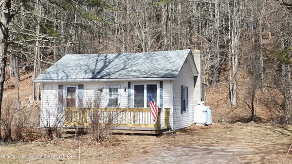 a view of patio with a table and chairs and floor to ceiling window