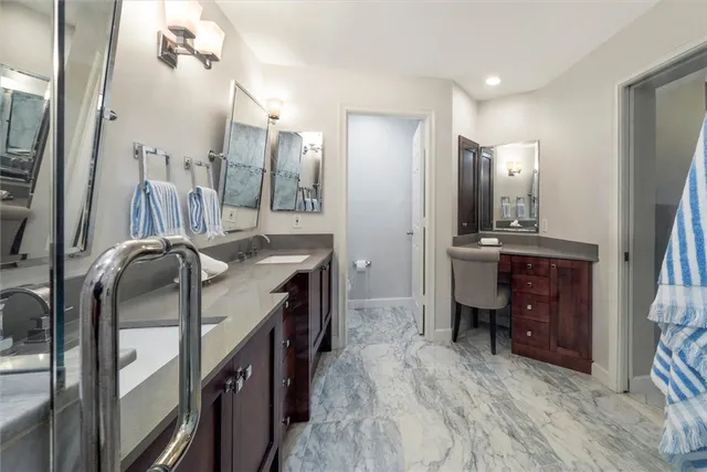 a bathroom with a sink a toilet and mirror