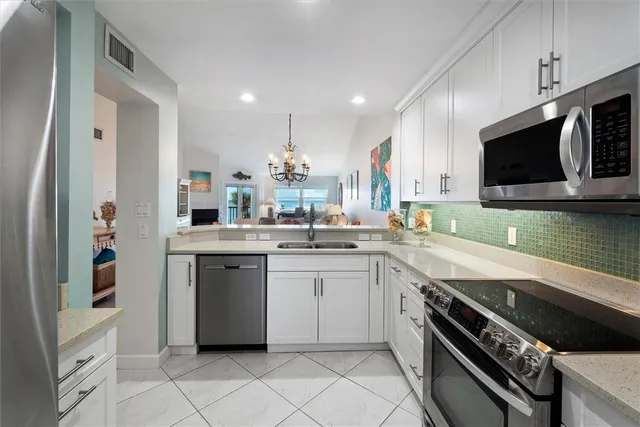 a kitchen with a sink stainless steel appliances and cabinets