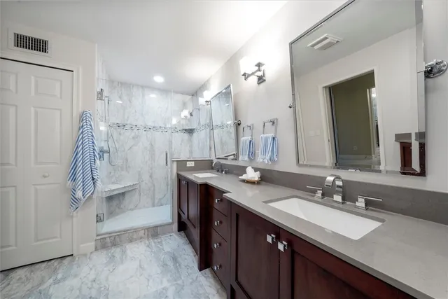 a bathroom with a sink double vanity and a mirror