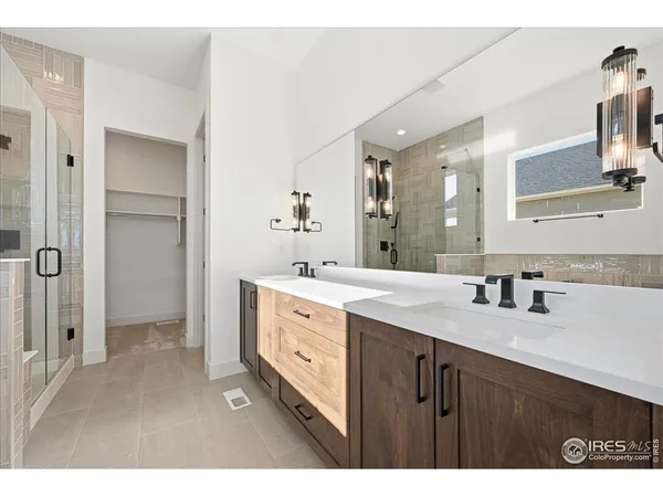 a bathroom with a sink double vanity and a mirror