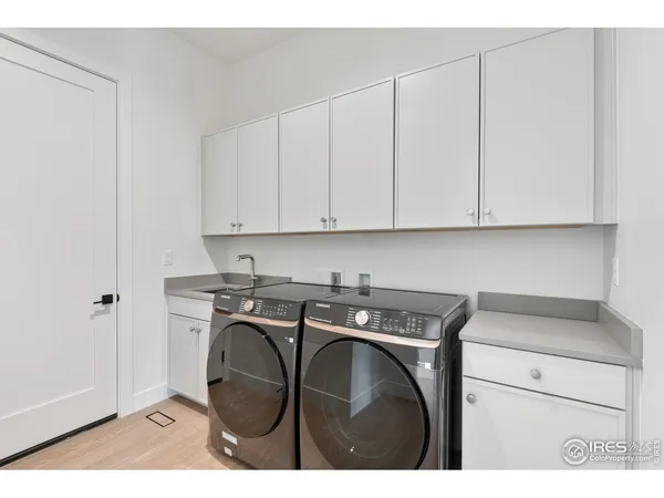 a utility room with cabinets washer and dryer