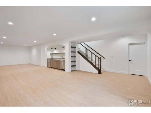 a view of an empty room with a kitchen