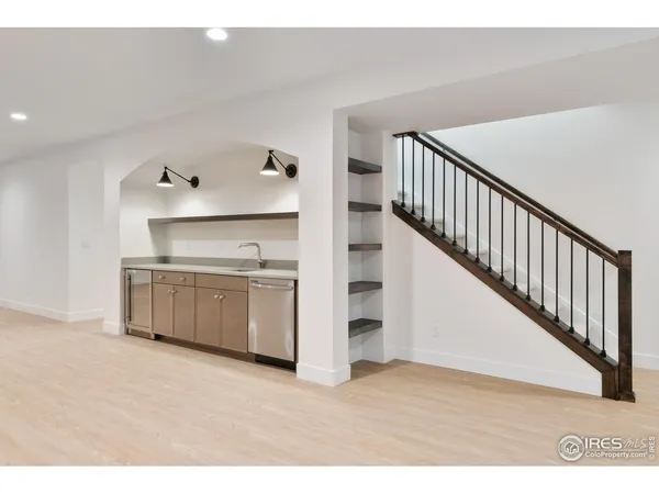 a view of a kitchen with wooden floor and stairs