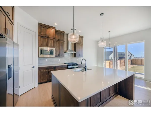 a kitchen with a sink a counter space and stainless steel appliances