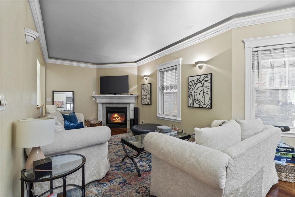 733 East 3rd Street Boston, MA 02127 - Photo 5 of 12 a living room with furniture a flat screen tv and a fireplace