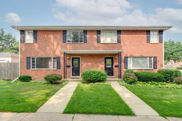 a front view of a house with garden and porch