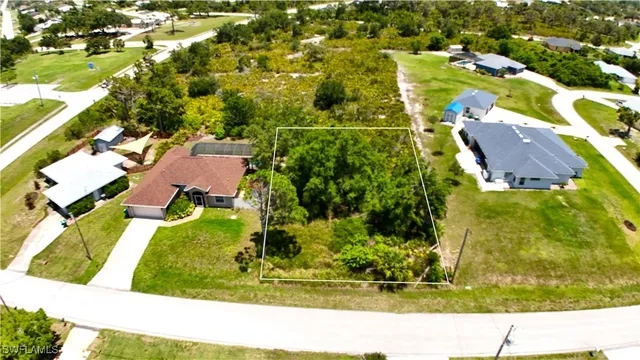 an aerial view of residential houses with yard