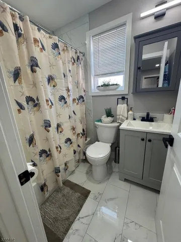a bathroom with a sink toilet and mirror