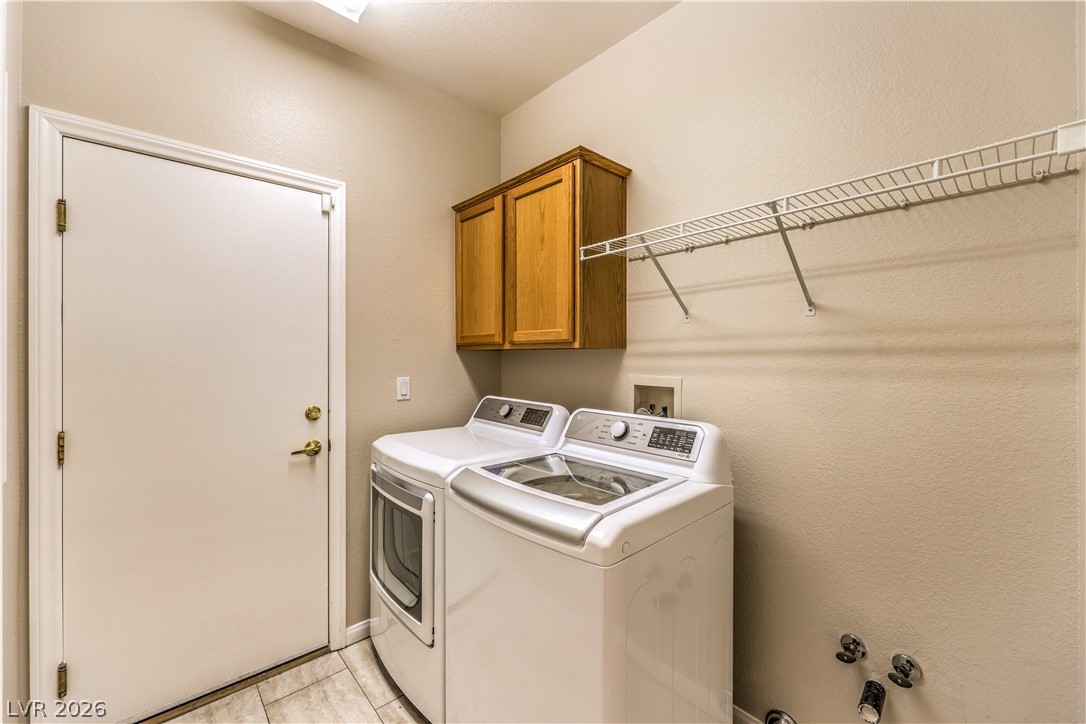 3713 Spring Shadow Road Las Vegas, NV 89129 - Photo 31 of 37 This laundry room provides efficient space with modern appliances and practical storage.
