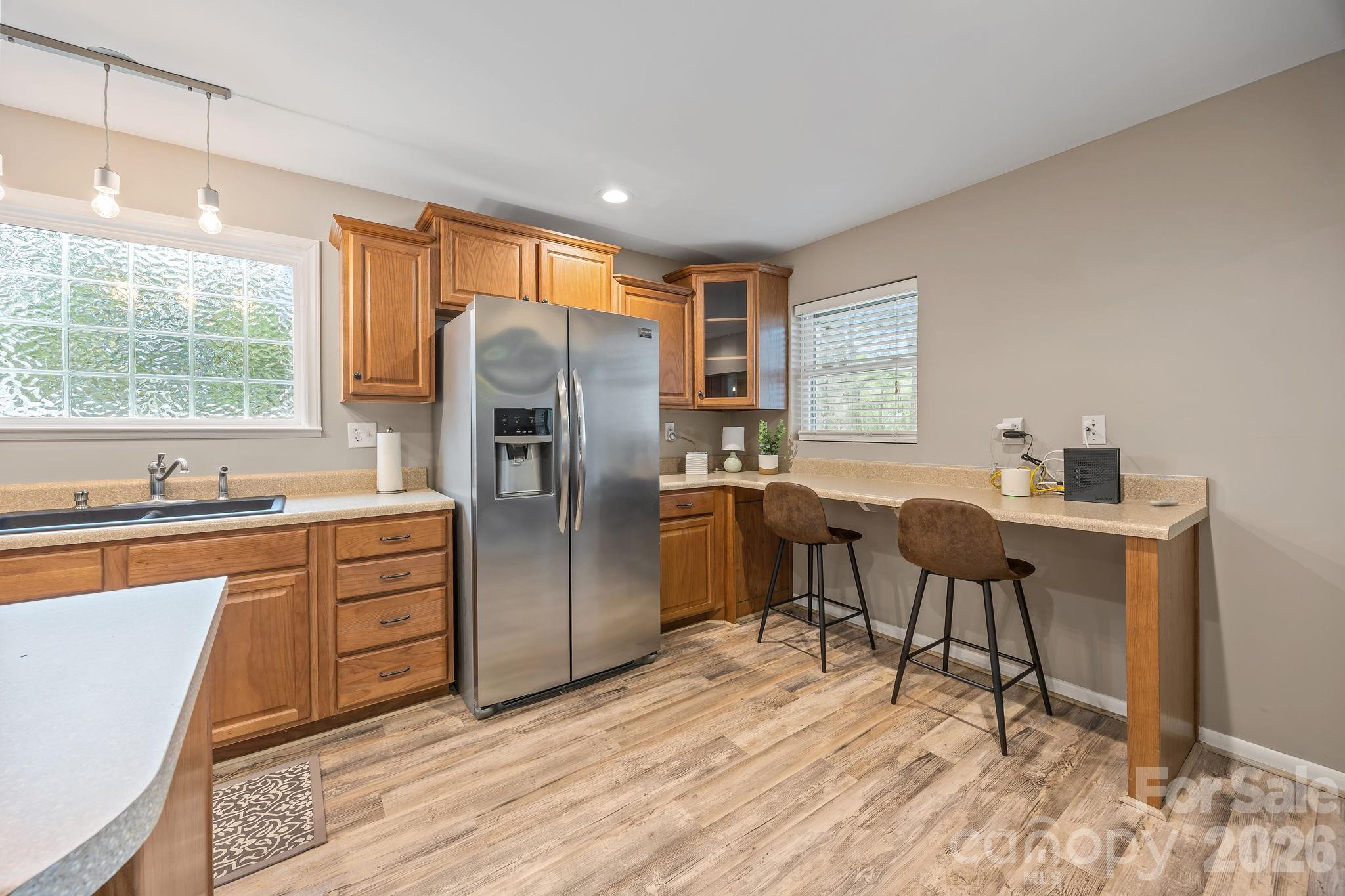1870 Scout Road Salisbury, NC 28146 - Photo 19 of 48 a kitchen with stainless steel appliances granite countertop a refrigerator a sink dishwasher a stove and a dining table with wooden floor