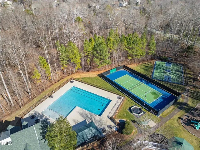 a view of a dry yard with wooden fence