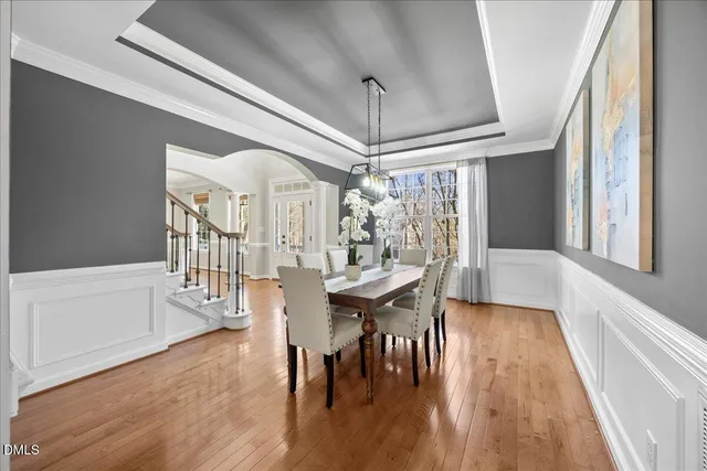 a hallway with white cabinets and wooden floor