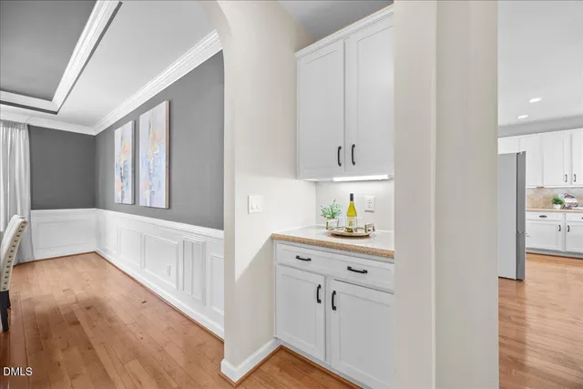 a living room with furniture a fireplace and a chandelier