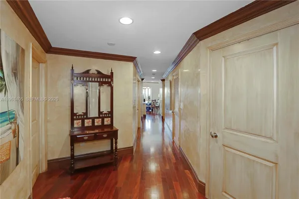 a view of a hallway with wooden floor and furniture
