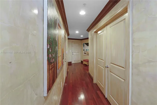 a view of a hallway with wooden floor