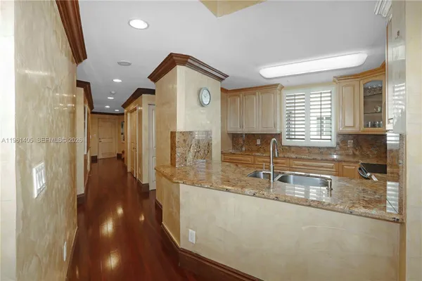 a view of a kitchen with a sink and wooden floor