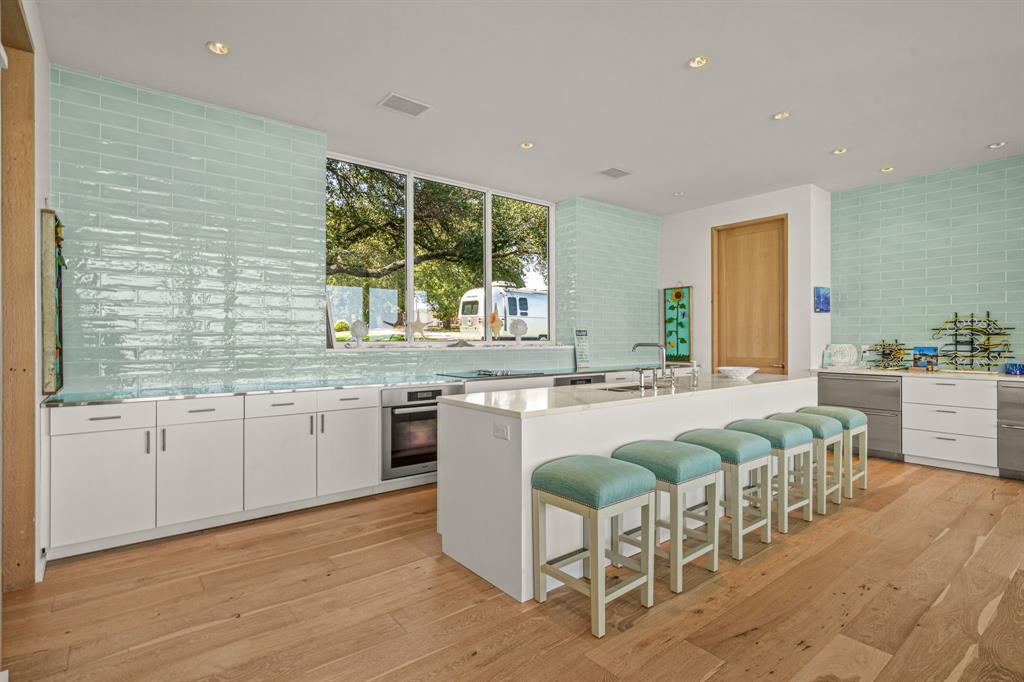 7145 Hickey Road Azle, TX 76020 - Photo 13 of 40 a large kitchen with kitchen island granite countertop a stove a sink a dining table and chairs