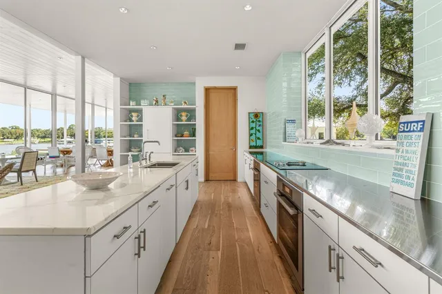 a large white room with a large window and furniture