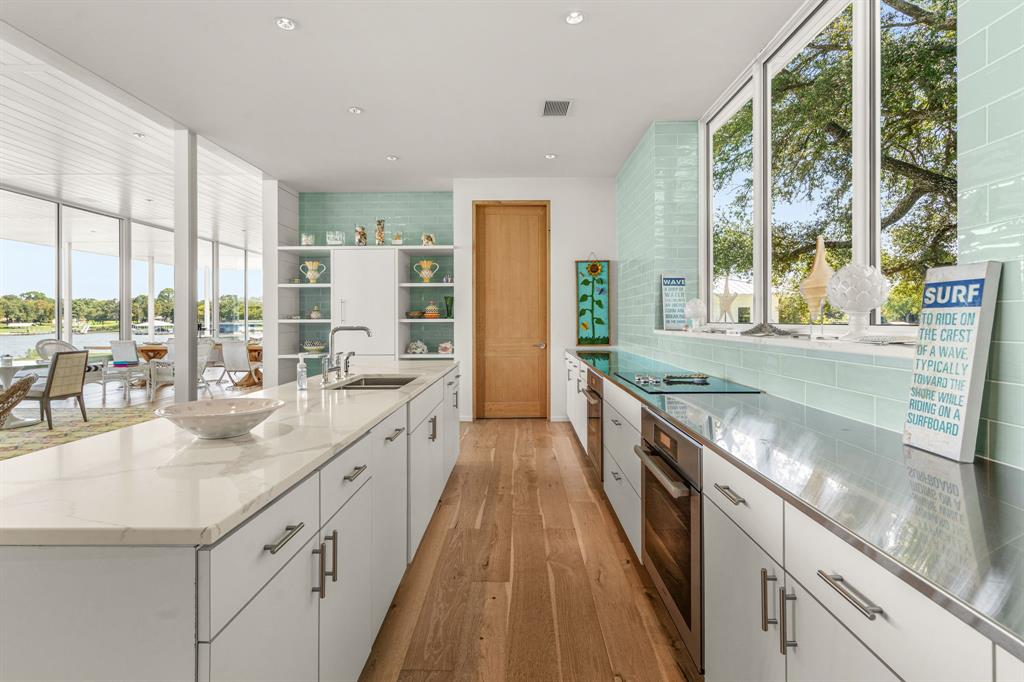 7145 Hickey Road Azle, TX 76020 - Photo 14 of 40 a large kitchen with stainless steel appliances granite countertop a sink and cabinets