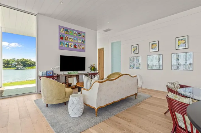 a living room with furniture and a floor to ceiling window