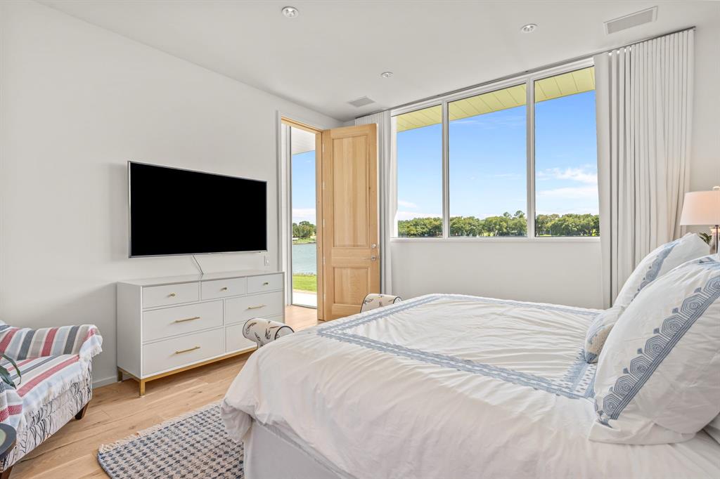 7145 Hickey Road Azle, TX 76020 - Photo 21 of 40 a bedroom with a bed and a flat screen tv