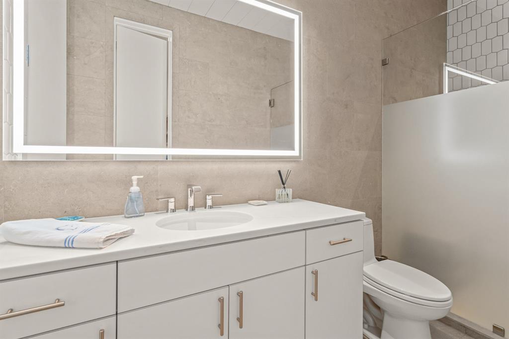 7145 Hickey Road Azle, TX 76020 - Photo 22 of 40 a bathroom with a toilet sink and mirror