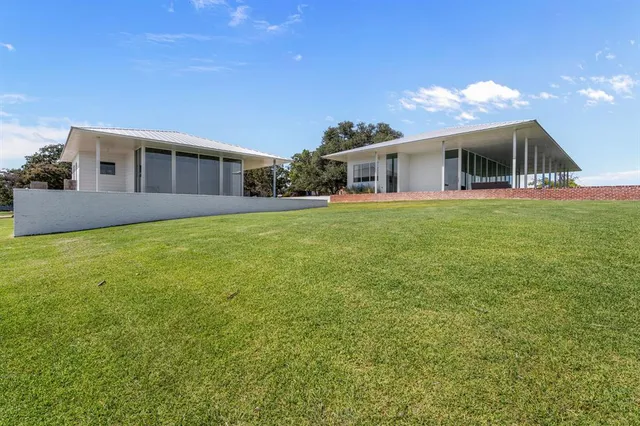 a view of a chair and tables in the back yard of the house