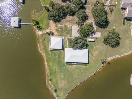 an aerial view of a house with a mountain
