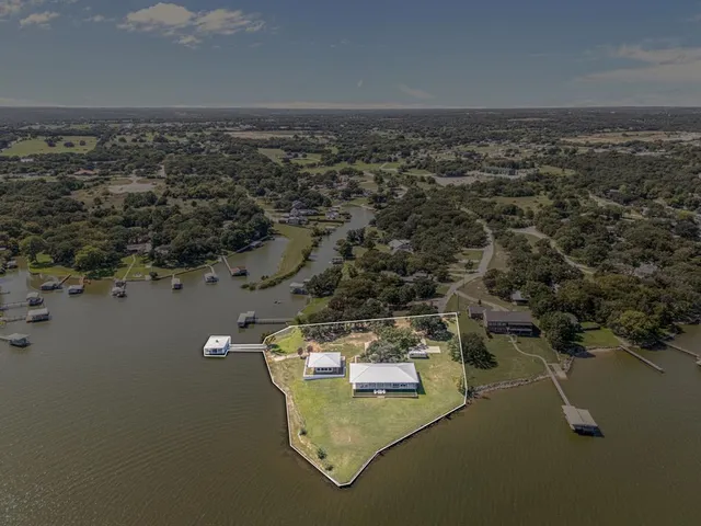 an aerial view of a house with a lake view
