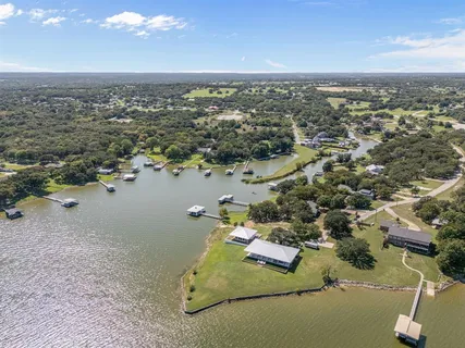 an aerial view of a houses with a lake view