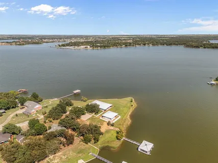 an aerial view of a house with a lake view