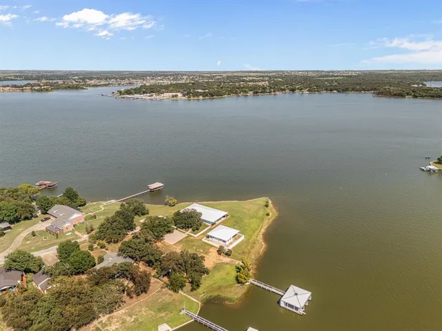 an aerial view of a house with a lake view