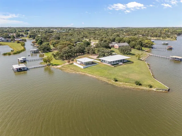 a view of a lake with houses in the back