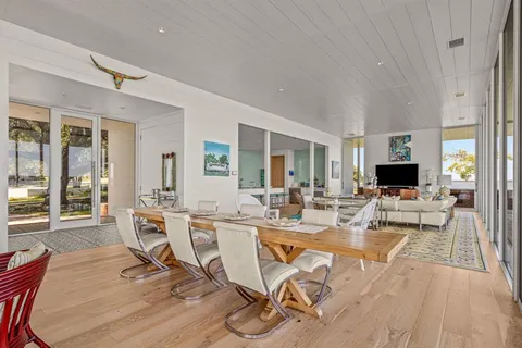 a very nice looking living room with a large window and a table