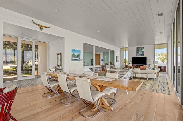 a very nice looking living room with a large window and a table