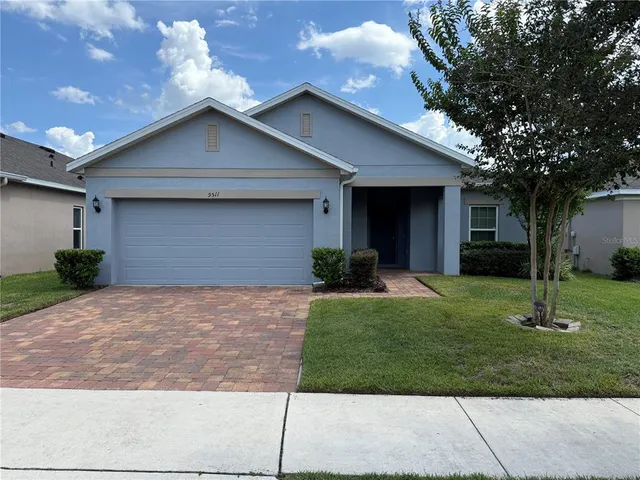 a front view of house with a garden
