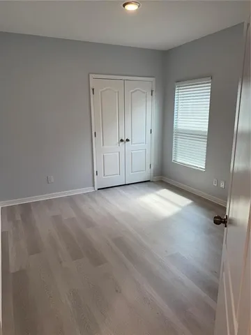 a bathroom with a granite countertop sink a mirror and a bathtub