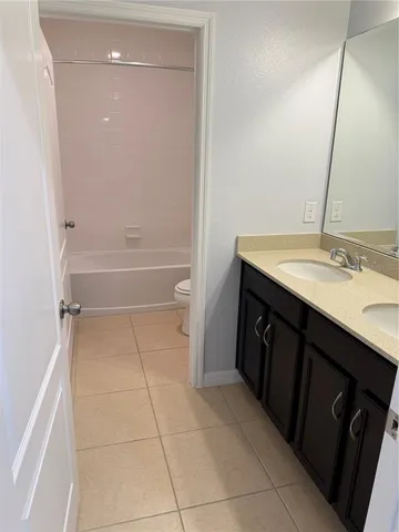 a bathroom with a double vanity sink a and a mirror