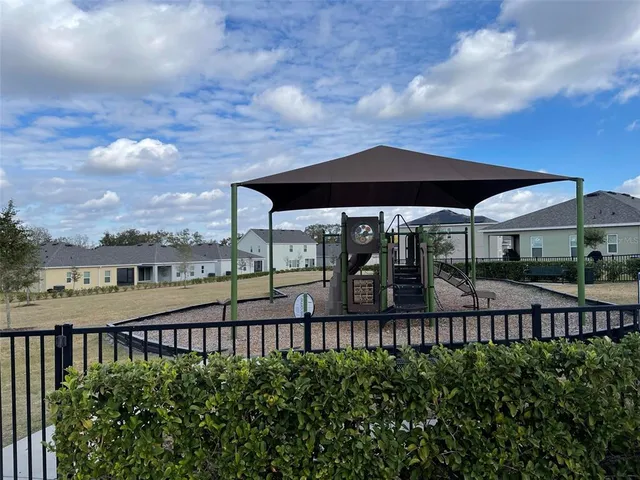 a view of a swimming pool with an outdoor seating and a yard