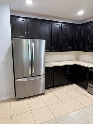a kitchen with wooden cabinets