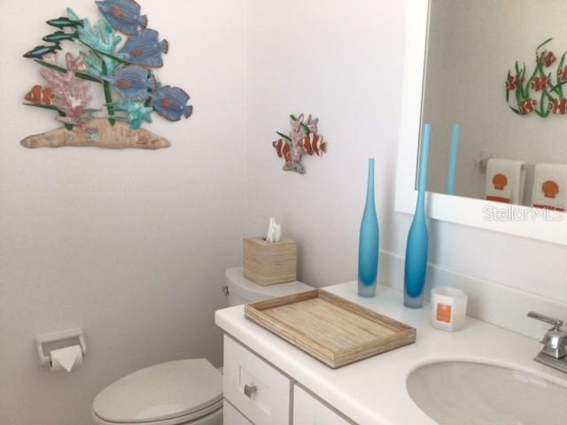 420 Gulf Boulevard, Unit 6 Boca Grande, FL 33921 - Photo 15 of 26 a bathroom with a toilet sink and mirror
