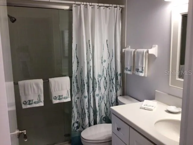 a bathroom with a sink toilet and mirror