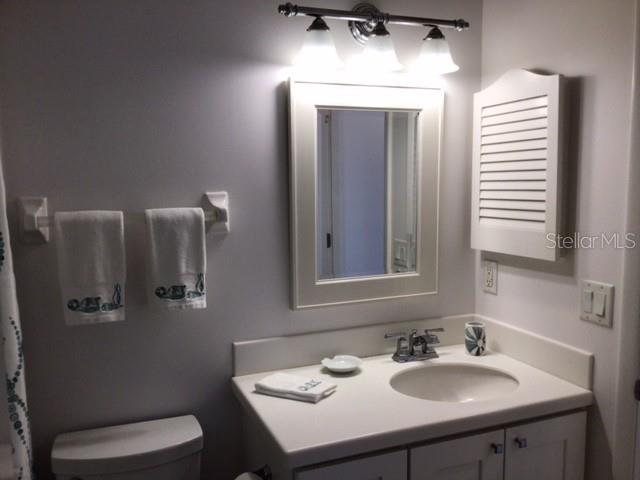 420 Gulf Boulevard, Unit 6 Boca Grande, FL 33921 - Photo 21 of 26 a bathroom with a sink toilet and mirror