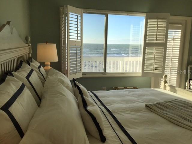 420 Gulf Boulevard, Unit 6 Boca Grande, FL 33921 - Photo 23 of 26 a bed sitting in a bedroom next to a window